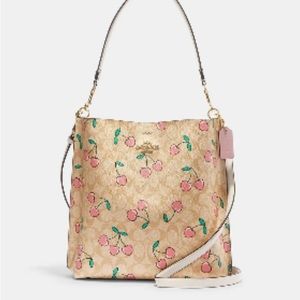 EUC Coach large Mollie Bucket in signature print with cherries.